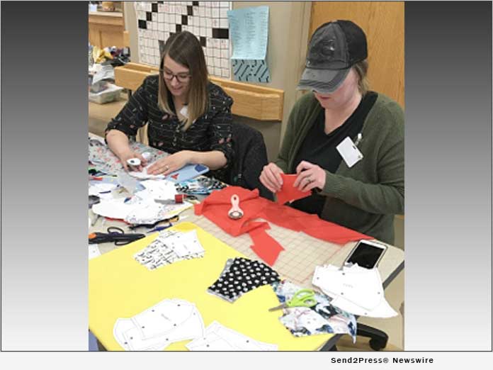 Sara Hiatt and Keri Barton work together on mask templates