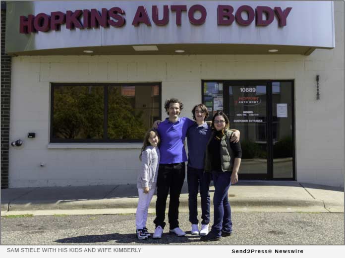 Sam Stiele with his kids and wife Kimberly in front of Hopkins Auto Body