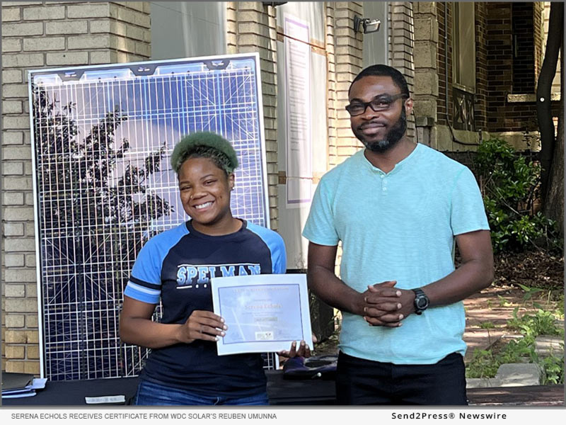 Serena Echols receives a certificate from WDC Solar’s Reuben Umunna