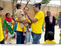 Scientology Volunteer Assist Team of Pakistan examines a boy at a Karachi shelter