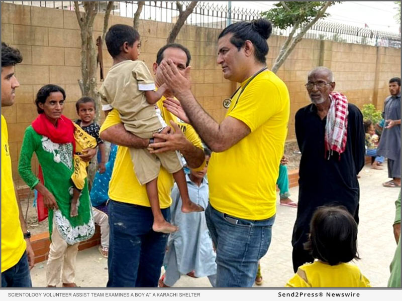 Scientology Volunteer Assist Team of Pakistan examines a boy at a Karachi shelter
