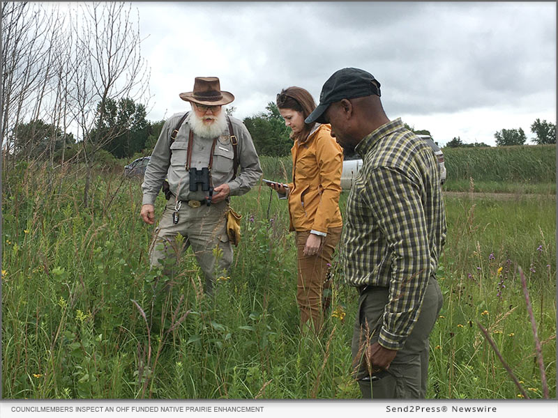 Councilmembers Dudley Edmondson (right) and Ashley Peters (middle) inspect an OHF funded native prairie enhancement in Clay county with retired wildlife manager Earl Johnson (left) during an August 2022 LSOHC habitat tour