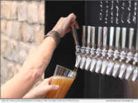 One of Loco LIon's bartenders pouring a pint of Nigel's Bitter & Twisted Ale