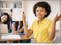 A student holds a graded math assignment, illustrating how strong grades can mask underlying gaps in conceptual understanding