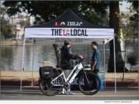 A member of The LA Local's community engagement team speaks with a resident in the Westlake neighborhood of Los Angeles. Photo Credit: The LA Local.
