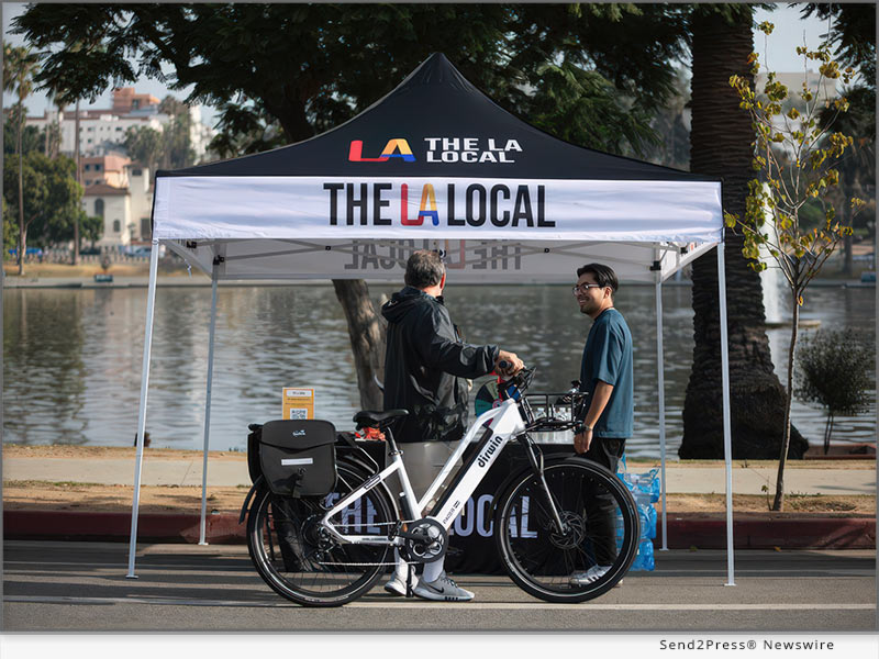 A member of The LA Local's community engagement team speaks with a resident in the Westlake neighborhood of Los Angeles. Photo Credit: The LA Local.