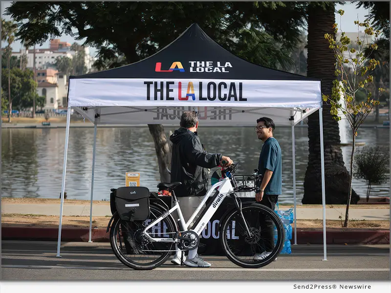 A member of The LA Local's community engagement team speaks with a resident in the Westlake neighborhood of Los Angeles. Photo Credit: The LA Local.