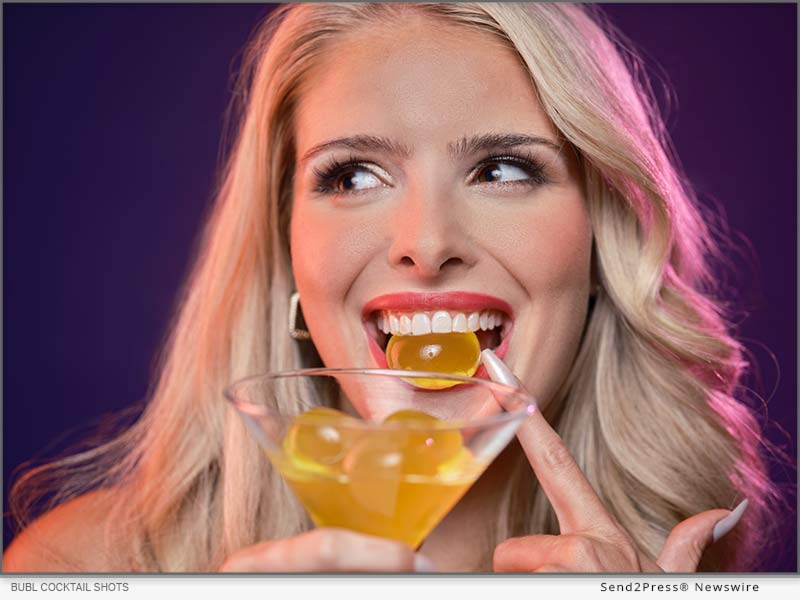 Bubl Cocktail Shots displayed in use with additional shots in a martini glass. Thanks to the products edible capsule format, Bubl Cocktail Shots can be picked up by hand and enjoyed, or placed in a glass