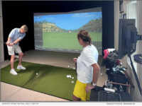Jenner's Pond resident Newt Brosius celebrates the opening of its new Virtual Golf Center